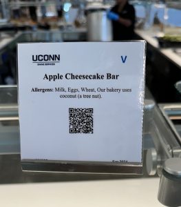 nutritional card in the dining hall for an apple cheesecake bar that shows allergens and qr code