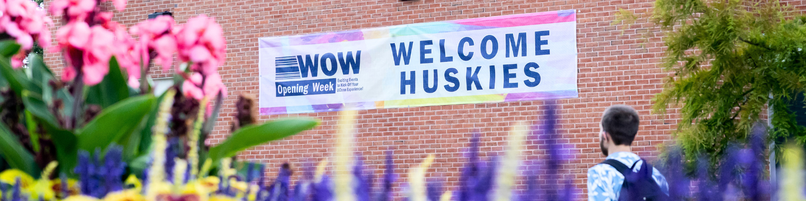 welcome huskies banner on side of brick building